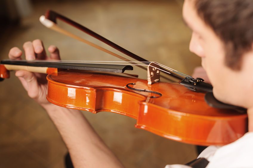 Playing the violin. Top view of men playing the violin