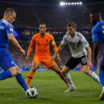 revivez le duel intense de la coupe du monde où gudmundsson et l'ex-lillois pépé affrontent les redoutables équipes des pays-bas et d'allemagne dans une bataille épique.
